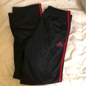 red strip adidas track pants